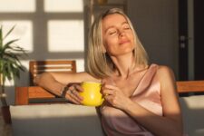 Attractive,Happy,Middle,Aged,Woman,Is,Sitting,On,Sofa,In