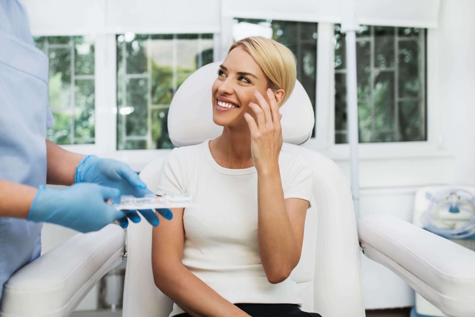 beautiful blonde woman smiling in medical chair